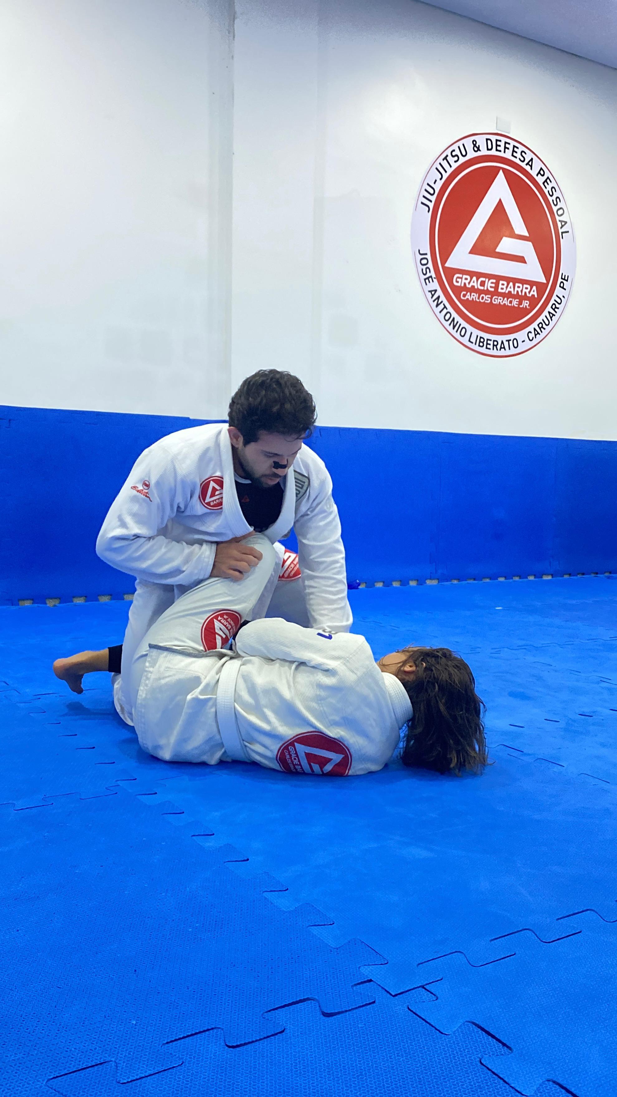 Treino de Jiu-Jitsu — professor demonstrando técnica no tatame